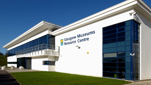 Exterior of Glasgow Museums Resource Centre. The centre is a large, white building with big glass windows.