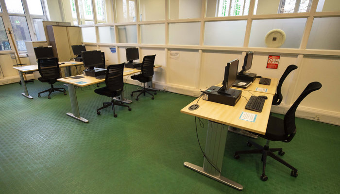 PC area with 3 tables and 2 PC's at each table.