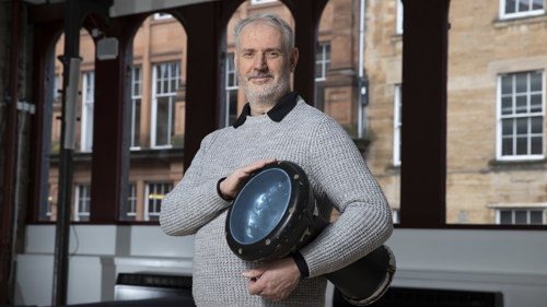 Conductor Paul MacAlindin poses with a drum