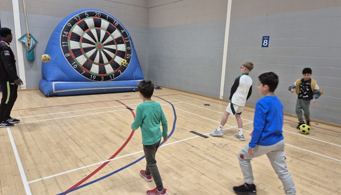 Children playing with an inflatable target. 