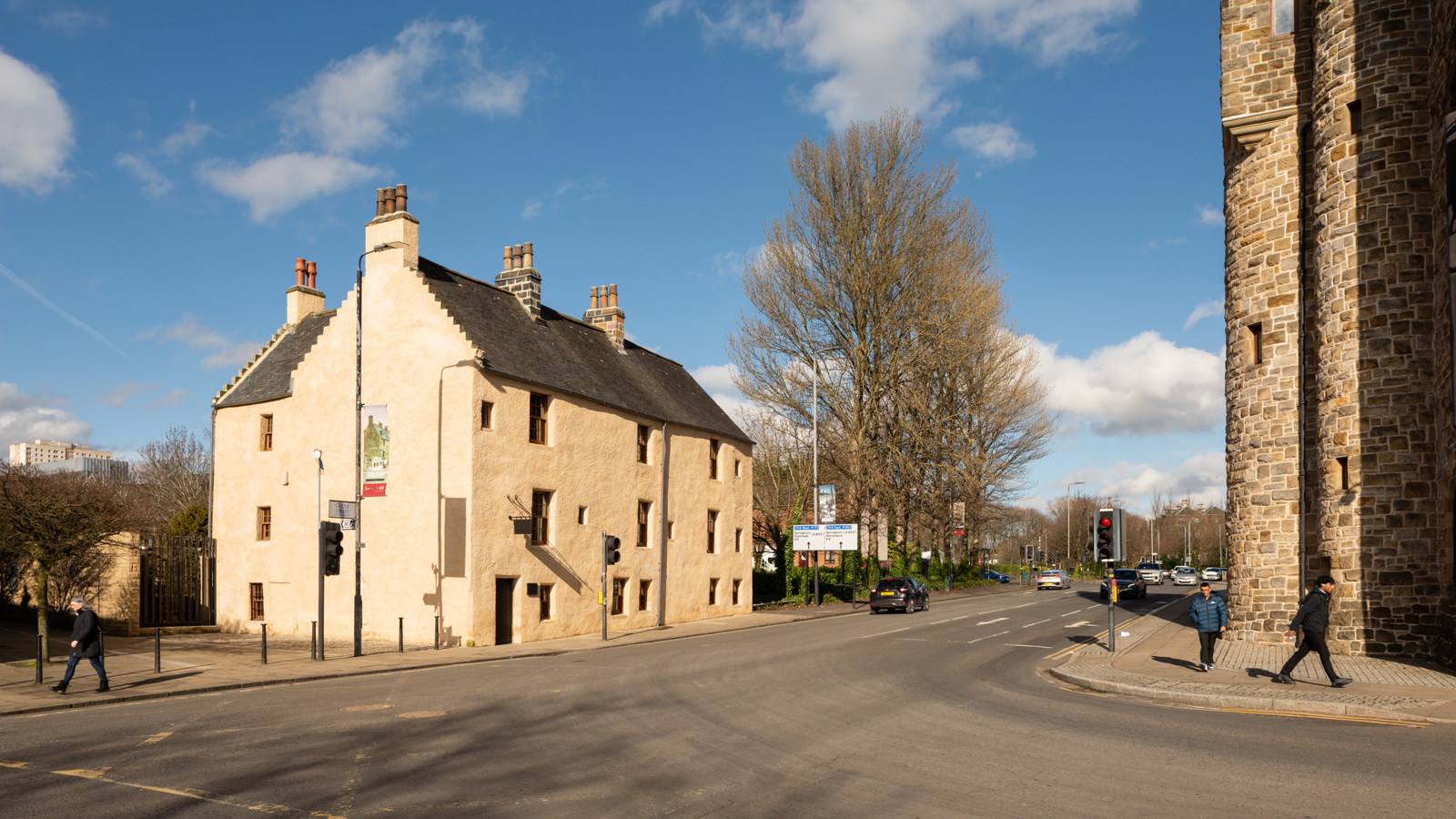 A wide angle shot of a white building dating back to the 1400s.