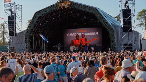 A large crowd of festivalgoers enjoy a concert