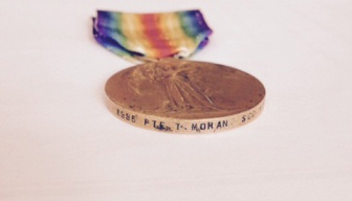 Thomas Moran's medal, which is gold with a rainbow coloured lanyard, for The Great War of Civilisation 1914-1919, inscribed with Thomas’ name and regimental number on the rim.